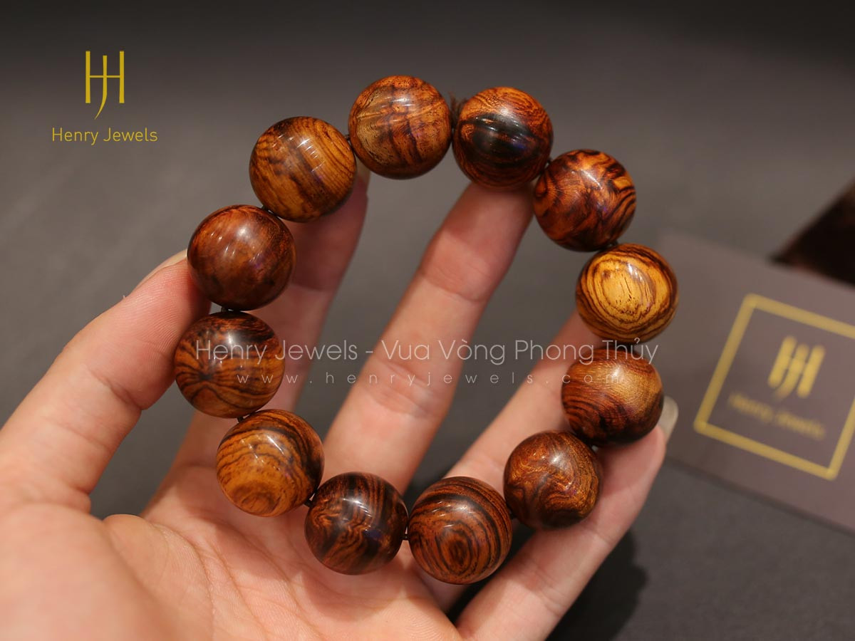 Vòng tay gỗ sưa đỏ Quảng Bình với đường vân gỗ nổi bật, tượng trưng cho sức mạnh và nhiệt huyết của người mệnh Hỏa